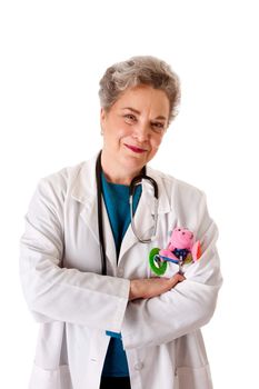 Beautiful happy smiling friendly experienced pediatrician nurse physician standing, isolated. Doctor for children with toy in pocket and stethoscope around neck and arms crossed.