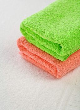 pink and green towels on white background