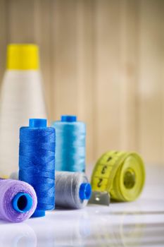 sewing spools with threads and tapeline