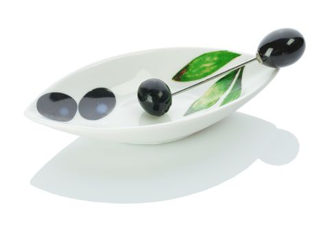 single olive on a plate with skewer