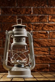 white kerosene lamp on background of the brickwall