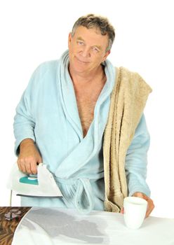 Middle aged man in bath robe with a cup of tea deals with a leaking steam iron.