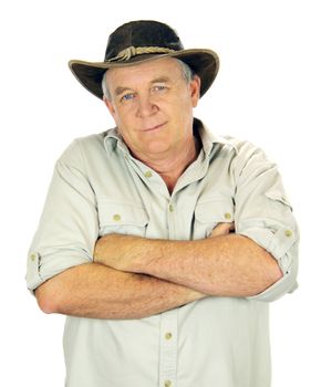 Casual middle aged man standing with arms crossed with a hat.