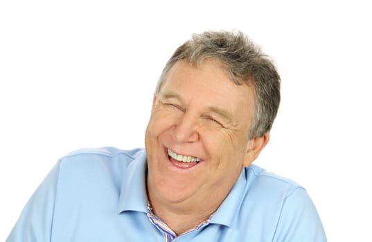 Close up of a middle aged man laughing heartily looking away from camera.