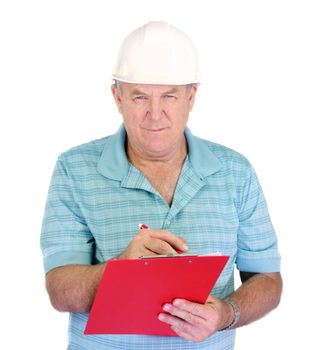 Middle aged construction foreman takes notes on his clipboard.