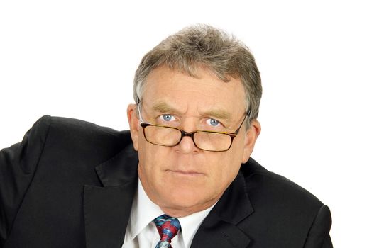 Determined middle aged businessman looks directly at camera.