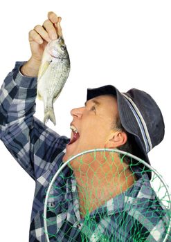 Middle aged fisherman pretends to drop a fresh raw fish into his mouth.