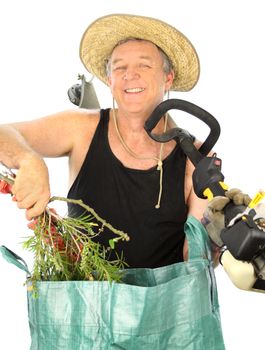 Middle aged gardener with grass cutter puts his garden clippings into a rubbish bag.