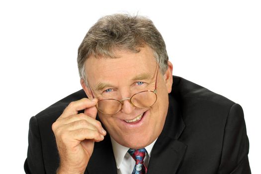 Smiling middle aged businessman looks over his glasses.