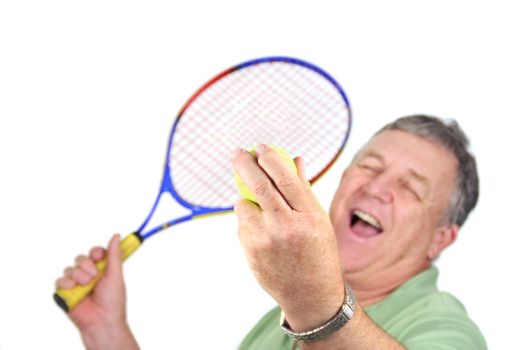 Middle aged man about to serve a tennis ball.