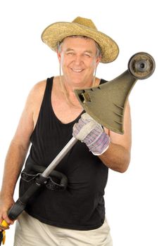 Smiling middle aged gardener holding a whipper snipper.
