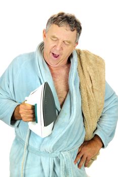 Yawning middle aged man in bath robe with iron.