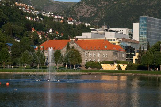 Little grove farm water in Bergen with water ancient seats and train station in the background.