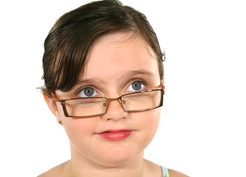 Little girl in glasses looking away above camera.