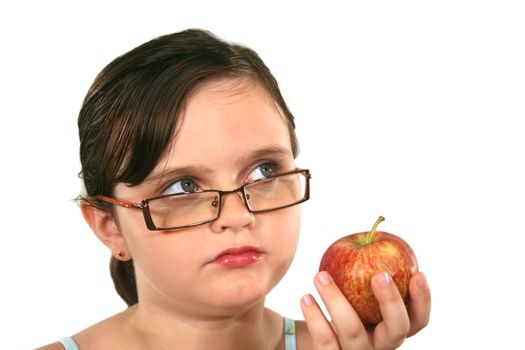 Cute and adorable young girl with glasses holding an apple.