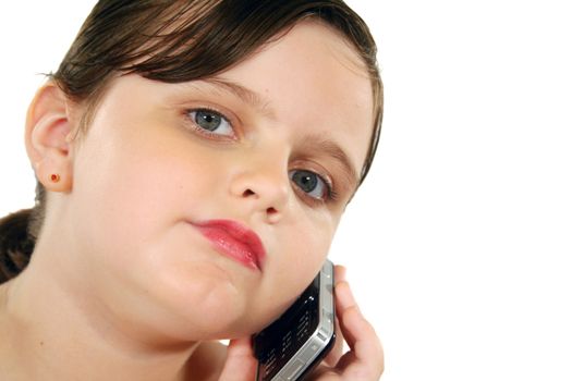 Little girl listening intently on her cell phone.