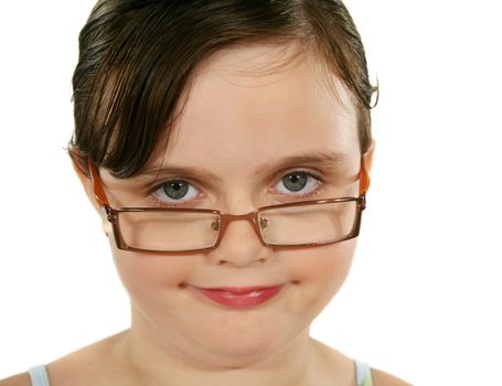 Little girl looking over her glasses smiling.