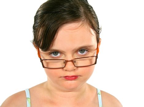 Close up of a little girl with glasses with serious look.