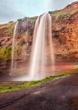Seljalandsfoss is one of the most beautiful waterfalls on the Iceland. It is located on the South of the island. This photo is taken during the incredible sunset at approx. 1 AM. 