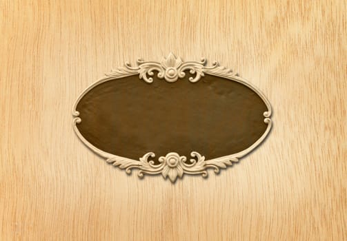 carved oval wood frame on wood background