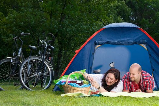 Happy young couple is relaxing on a camping