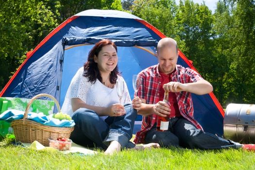 Happy young couple is relaxing on a camping