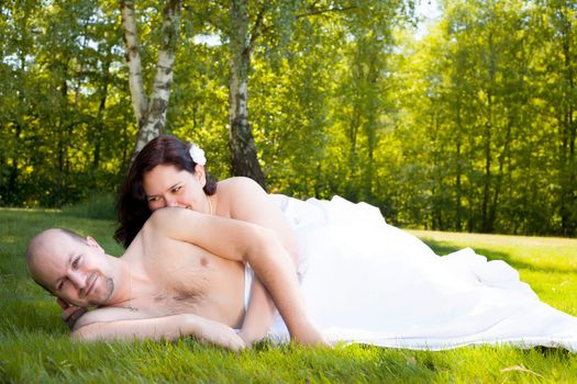 Happy young couple dressed white in the nature