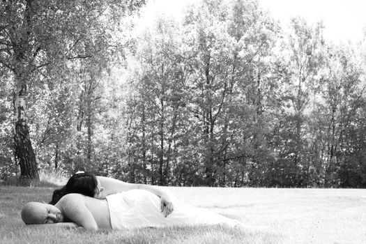 Happy young couple dressed white in the nature