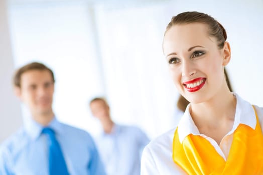 Portrait of a young successful business woman standing against colleagues