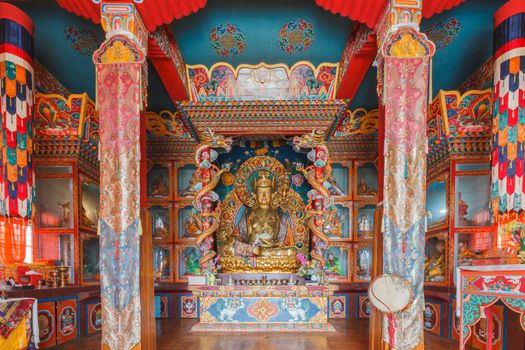 gilded metal statue of preaching Buddha in a Tibetan Buddhist monastery in Yoksom, sikkim,India