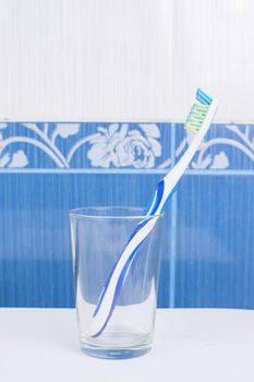 Toothbrush in glass in the bathroom. High resolution