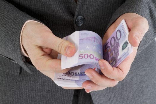 stack banknotes of five hundred euro in male hands