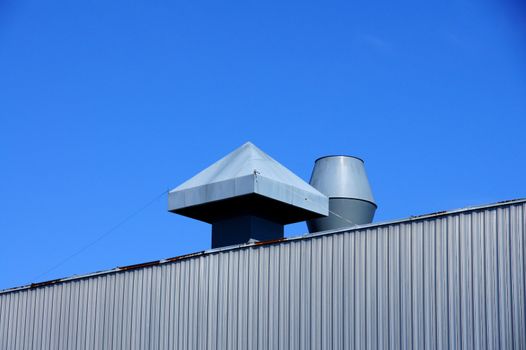 Pipes of ventilation on a background of blue sky