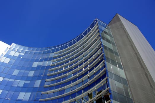 Modern office high building is constructed of glass and concrete 