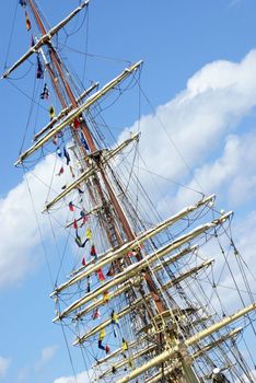 The top of a tall ship docked in the harbor.