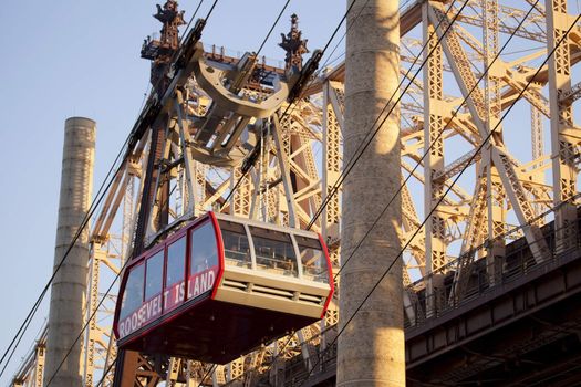 Red car of cableway near brridge from Manhattan to Roosevelt Island.
