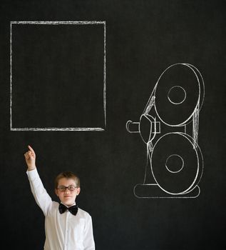Hand up answer boy dressed up as business man with retro chalk film projector on blackboard background
