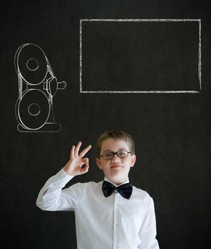 All ok or okay sign boy dressed up as business man with retro chalk film projector on blackboard background