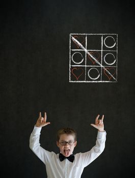 Knowledge rocks boy dressed up as business man with chalk tic tac toe love valentine concept on blackboard background