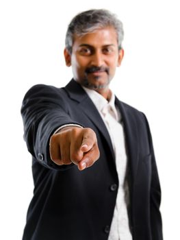 Good looking mature Asian Indian business man with business suit finger pointing at you, focus on finger, isolated on white background. Portrait of handsome Indian male model.