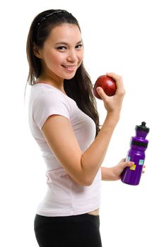 Healthy lifestyle concept. Fitness woman eating apple smiling happy looking at camera. Pretty mixed race Caucasian Southeast Asian woman isolated on white background.