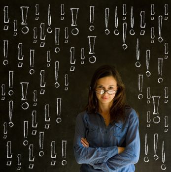 Businesswoman, student or teacher with chalk exclamation marks on blackboard background