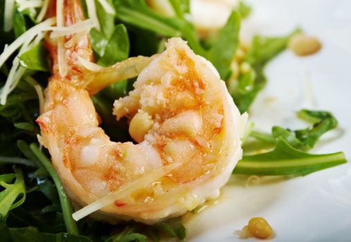 arugula salad with prawn on plate closeup