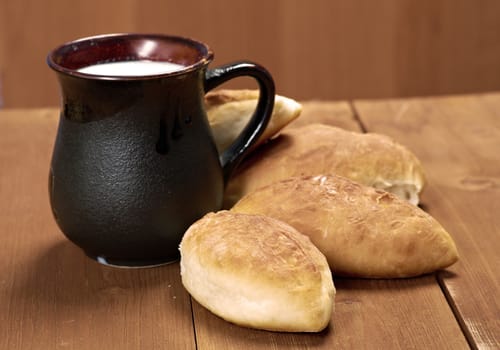 russia traditions pierogi .Home cake with cabbage against the wooden table