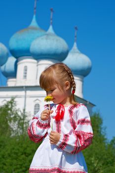 Russian little girl  on a orthodox church background.
