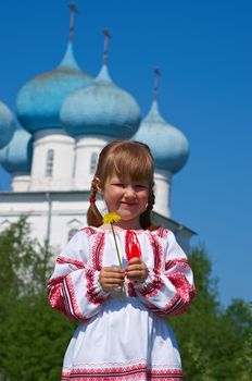 Russian little girl  on a orthodox church background.