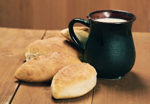 russia traditions pierogi .Home cake with cabbage against the wooden table