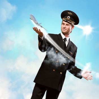 pilot in the form of extending a hand to a flying airplane on the background of clouds and sun