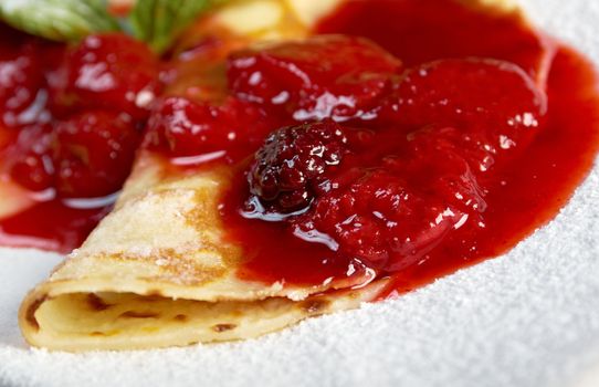 Pancakes with strawberry jam.closeup