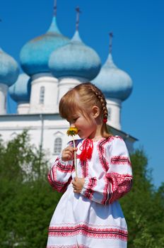 Russian little girl  on a orthodox church background.